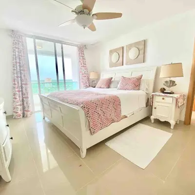 a white bedroom with a bed and a window at 3 Bedrooms At Marbella Beachfront Juan Dolio in Juan Dolio