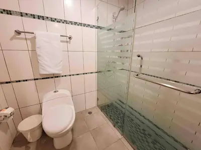 a bathroom with a toilet and a glass shower at 3 Bedrooms At Marbella Beachfront Juan Dolio in Juan Dolio