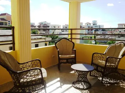 a balcony with chairs and a table on a balcony at Premium Single Room - Corales del Sur Ole Las Americas- Isabelita - Aeropuerto in La Viva
