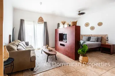 a living room with a couch and a bed at Ocean Dream 8205, 2Min to Beach! Apt Kite Paradise! in Cabarete