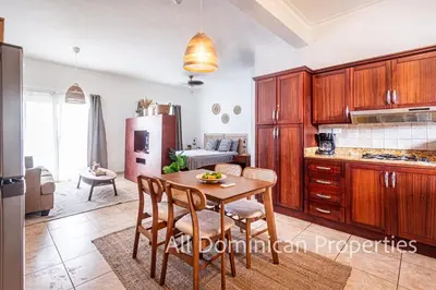 a kitchen with a table and chairs in a room at Ocean Dream 8205, 2Min to Beach! Apt Kite Paradise! in Cabarete