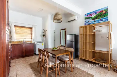 a kitchen with a table and chairs and a refrigerator at Ocean Dream 8205, 2Min to Beach! Apt Kite Paradise! in Cabarete