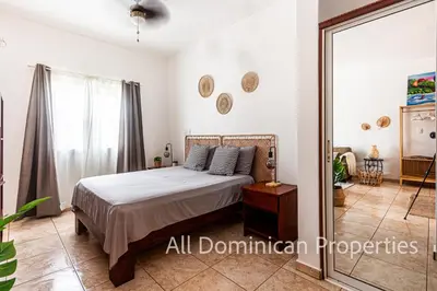 a bedroom with a bed and a mirror at Ocean Dream 8205, 2Min to Beach! Apt Kite Paradise! in Cabarete