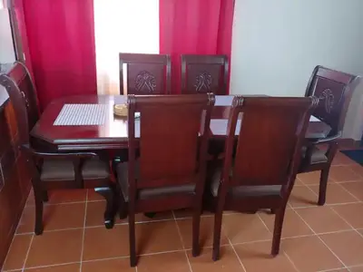 a dining room table and chairs with red curtains at Dominican Suite 2, Increíble apto. cama king (DS2) in San Felipe de Puerto Plata