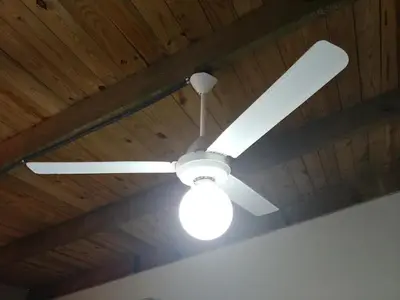 a ceiling fan with a light on a wooden ceiling at Dominican Suite 2, Increíble apto. cama king (DS2) in San Felipe de Puerto Plata