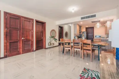 a kitchen and dining room with a table and chairs at Beautiful 2 BR apartment at Portillo in Las Terrenas