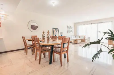 a dining room table and chairs in a living room at Beautiful 2 BR apartment at Portillo in Las Terrenas