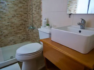 a bathroom with a white toilet and a sink at Lovely condo at Blue Sea Tower near Juan Dolio beach in Juan Pedro