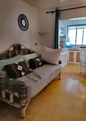 a couch with pillows on it in a living room at B&B Aparthotel La Isleta in Las Galeras