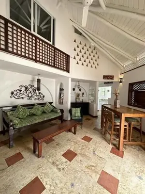 a living room with a couch and a table at Hotel Casa Coson in Las Terrenas