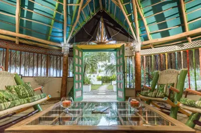 a living room with a glass table and chairs at Hotel Casa Coson in Las Terrenas