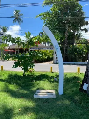 a white sculpture in the grass next to a street at Excelente apartamento en Las Terrenas, Playa Punta Popi. in Las Terrenas