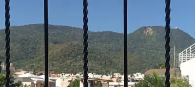 a view of a city from a window with mountains at HEA Stays in San Felipe de Puerto Plata
