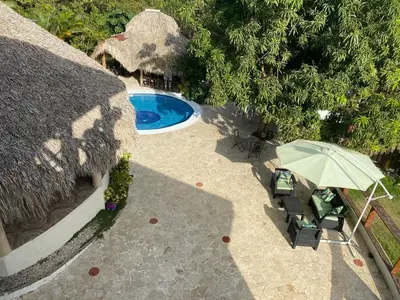 an overhead view of a patio with an umbrella and a pool at VILLA LOMAS LINDAS in La Montosa