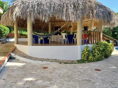 a gazebo with a hammock and chairs at VILLA LOMAS LINDAS in La Montosa