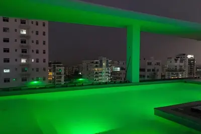 a green balcony with a view of a city at night at Brickell Hotel apto g 08 Santo Domingo Bella Vista in Santo Domingo