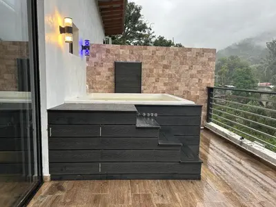a bath tub sitting on top of a balcony at Villa vista al rio in Jarabacoa
