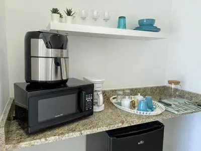 a kitchen counter with a coffee maker and a microwave at Elegant Blue Sky View Lux at Juan Dolio Las Velas in Juan Pedro