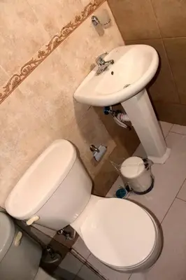 a bathroom with a white toilet and a sink at Dominican Suite 21, Amazing Apt/Studio (DS21) in San Felipe de Puerto Plata