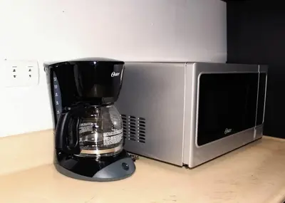 a coffee maker sitting next to a microwave at Dominican Suite 12, Incredible 2 Bed Apt (DS12) in San Felipe de Puerto Plata