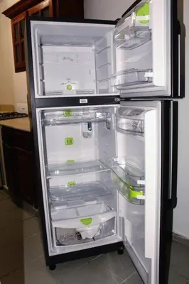 an empty refrigerator with its door open in a kitchen at Dominican Suite 12, Incredible 2 Bed Apt (DS12) in San Felipe de Puerto Plata