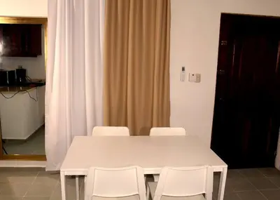 a white table and white chairs in a room at Dominican Suite 11, Amazing Apt/Studio (DS11) in San Felipe de Puerto Plata