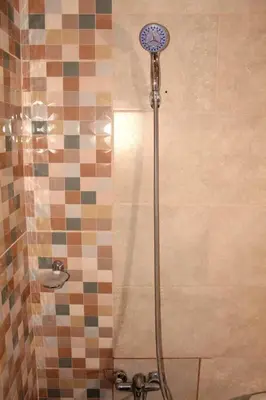 a shower with a shower head in a bathroom at Dominican Suite 11, Amazing Apt/Studio (DS11) in San Felipe de Puerto Plata