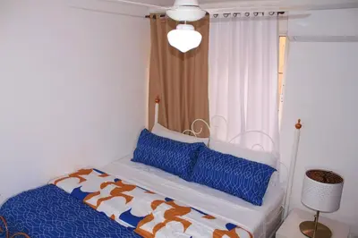 a bedroom with a bed with a canopy and blue pillows at Dominican Suite 23, Incredible 1 Bed Apt (DS23) in San Felipe de Puerto Plata