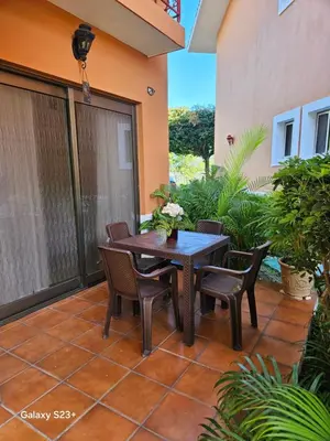a patio with a table and chairs on a house at Luxury apto 3 rooms+pool+ campo de golf. Cocotal in Punta Cana