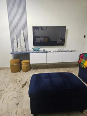 a living room with a large tv on a white cabinet at Luxury apto 3 rooms+pool+ campo de golf. Cocotal in Punta Cana
