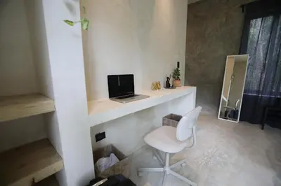 a room with a desk with a laptop and a chair at El Valle Villas in Santa Bárbara de Samaná