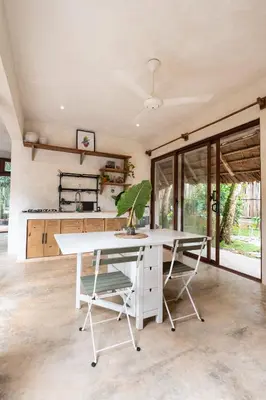 a dining room with a white table and chairs at El Valle Villas in Santa Bárbara de Samaná