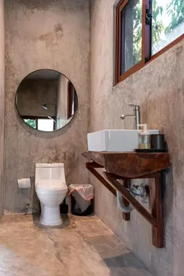 a bathroom with a toilet and a sink and a mirror at El Valle Villas in Santa Bárbara de Samaná