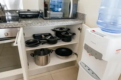 a kitchen with pots and pans on a shelf at Apartment Almas Iberosta Bavaro 3BDR with Pool & Private Beach in Punta Cana