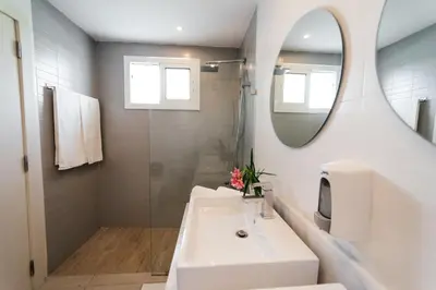 a white bathroom with a sink and a mirror at Apartment Almas Iberosta Bavaro 3BDR with Pool & Private Beach in Punta Cana