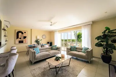 a living room with couches and a table at Apartment Almas Iberosta Bavaro 3BDR with Pool & Private Beach in Punta Cana