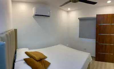 a bedroom with a bed with two pillows on it at Studios Don Bosco in Santo Domingo