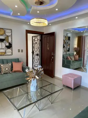 a living room with a glass table and a couch at VIP Home in Santiago de los Caballeros