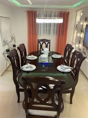 a dining room table and chairs in a room at VIP Home in Santiago de los Caballeros