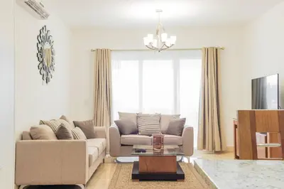 a living room with a couch and a table at Fortunity Club- Playa Dorada, Pto Plata in Sampiño
