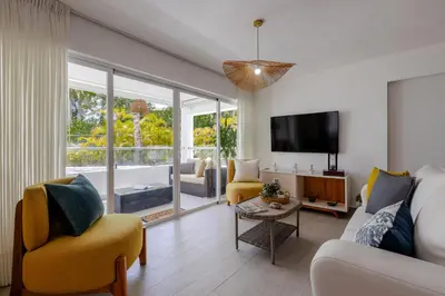a living room with a couch and a tv at Fortunity Club- Playa Dorada, Pto Plata in Sampiño