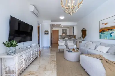 a living room with a couch and a tv at Fortunity Club- Playa Dorada, Pto Plata in Sampiño