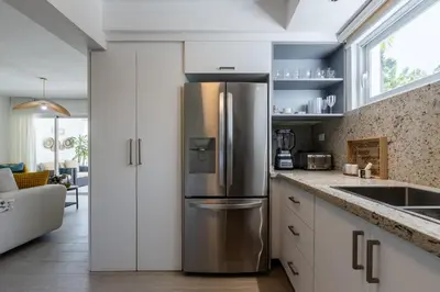 a kitchen with a stainless steel refrigerator at Fortunity Club- Playa Dorada, Pto Plata in Sampiño
