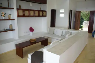 a living room with a white couch and a table at Villa del Mar in Punta Balandra