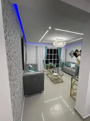 a living room with a couch and a blue ceiling at Luxury apartment with Pool in Santiago de los Caballeros