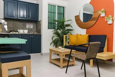 a living room with a couch and a table and chairs at Residencial Frank I in Santo Domingo