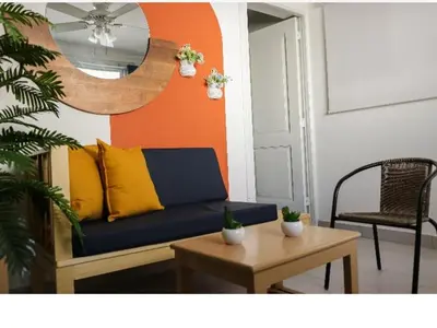 a living room with a blue couch and a table at Residencial Frank I in Santo Domingo