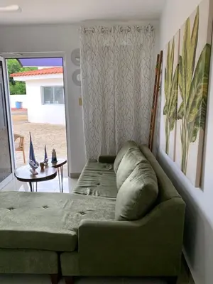 a living room with a couch and a table at Juan Dolio apart1 hab in Juan Pedro