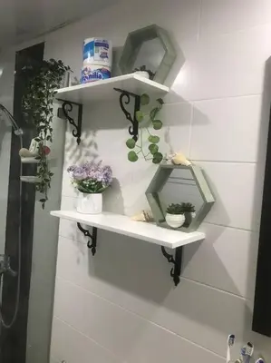 a bathroom with white shelves with plants on the wall at Juan Dolio apart1 hab in Juan Pedro