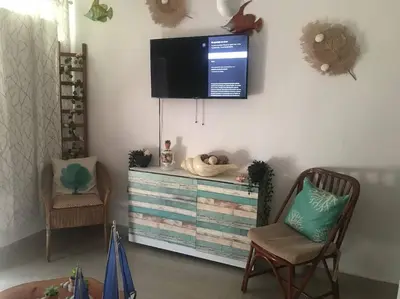 a living room with a television on a wall at Juan Dolio apart1 hab in Juan Pedro